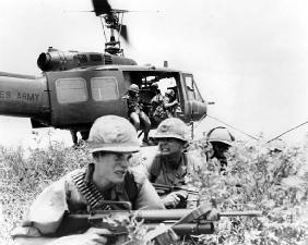 American soldiers exit a helicopter during Operation Oregon in the Vietnam War