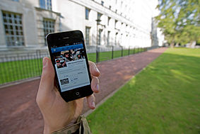 A serviceman accesses social media channels using a smart phone, outside MOD Main Building in London MOD 45156045.jpg