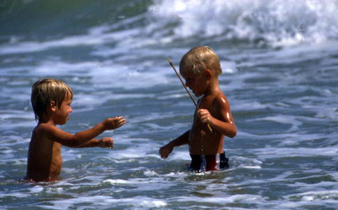 boys playing in sea