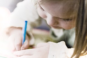 Little girl drawing with blue pencil.jpg